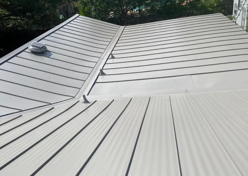 Solar attic fan installed on a metal roof for Roof Ventilation in Garfield
